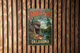 A vintage-style metal sign for Robbers Cave State Park in Oklahoma, featuring a scenic image of the park's natural landscape.