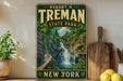 A vintage-style sign for Robert H. Treman State Park in New York, featuring a scenic image of a waterfall surrounded by lush greenery.