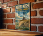 A vintage-style metal sign for Robert Moses State Park in Long Island, New York, featuring a lighthouse and beach scene.