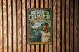 A vintage poster featuring a baseball player, likely Roberto Clemente, with a scenic background of a river and a park.