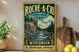 a vintage-style metal sign for Roche-A-CRI State Park in Wisconsin, with a scenic illustration of a river and forest landscape.