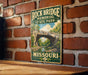 A vintage-style metal sign for Rock Bridge Memorial State Park in Missouri, featuring an illustration of the bridge and surrounding landscape.
