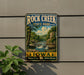 A vintage-style sign for Rock Creek State Park in Iowa, featuring a scenic landscape with a waterfall and lush greenery.