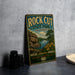 A vintage-style metal sign for Rock Cut State Park in Illinois, featuring a scenic landscape with a river, cliffs, and flowers.