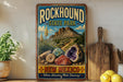 A vintage-style sign for Rockhound State Park in New Mexico, featuring a desert landscape with mountains, cacti, and colorful rocks.