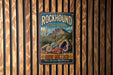 A vintage-style metal sign for Rockhound State Park in New Mexico, featuring a desert landscape with mountains and cacti.