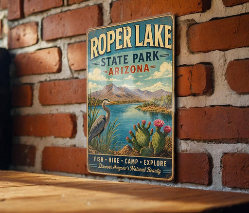 A vintage-style metal sign for Roper Lake State Park in Arizona, featuring a scenic landscape with mountains, a lake, and various flora and fauna.