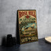 A vintage-style metal sign for the Rose Hill Plantation State Historic Site in South Carolina, featuring an illustration of a plantation house surrounded by palm trees and flowers.
