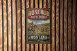 A vintage metal sign for Rosebud Battlefield State Park in Montana, featuring a cowboy on horseback and the text "Remember the past, honor the legacy".