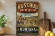 A vintage-style metal sign for Rosebud Battlefield State Park in Montana, featuring a painting of Native American people on horseback in a field.
