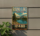 A vintage-style metal sign for Round Lake State Park in Idaho, featuring a scenic landscape with mountains, a lake, and pine trees.