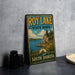 A vintage-style metal sign for Roy Lake State Park in South Dakota, featuring a scenic landscape with a lake, mountains, and pine trees.