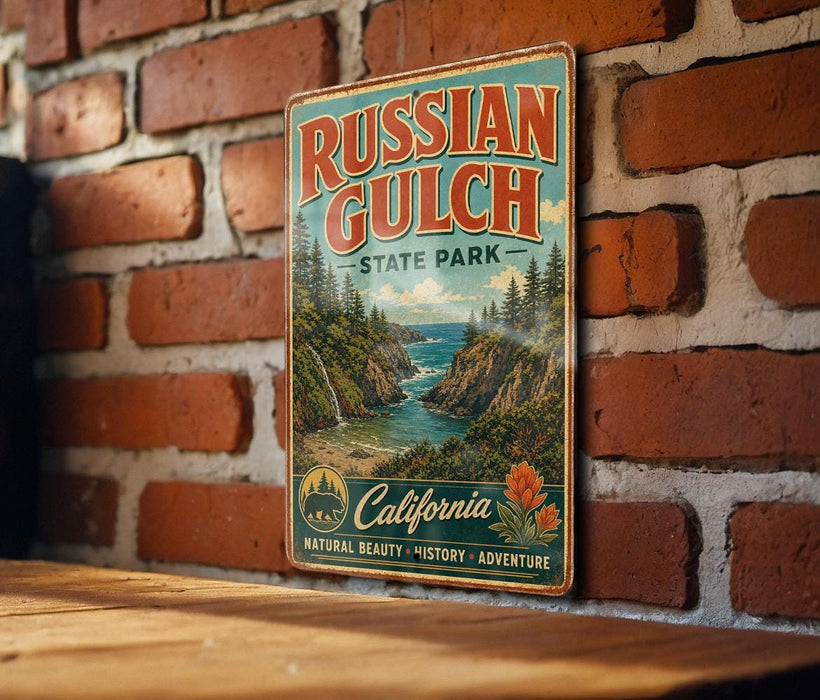 A vintage-style metal sign for Russian Gulch State Park, featuring a scenic landscape with a river, mountains, and pine trees.