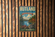 A vintage metal sign for Rutland State Park in Massachusetts, featuring a scenic landscape with pine trees, a lake, and mountains.