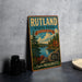 A vintage metal sign for Rutland State Park in Massachusetts, featuring a scenic landscape with pine trees, a lake, and mountains.