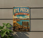 A vintage-style metal sign for Rye Patch State Recreation Area in Nevada, featuring a scenic landscape with mountains, a lake, and desert vegetation.