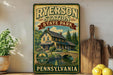 A vintage-style metal sign for Ryerson Station State Park in Pennsylvania, featuring a house and a bridge in a scenic landscape.