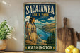 A vintage-style metal sign for Sacajawea State Park in Washington, featuring an illustration of a woman carrying a child and a scenic landscape.