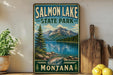 A vintage-style sign for Salmon Lake State Park in Montana, featuring a scenic mountain landscape with a lake and pine trees.