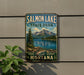 A metal sign displaying the name "Salmon Lake State Park Montana" with a scenic mountain landscape and a fish illustration.