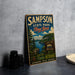 A vintage-style metal sign for Sampson State Park in New York, featuring a scenic landscape with a lake and mountains.