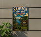 A vintage metal sign for Sampson State Park in New York, featuring a scenic landscape with pine trees, a lake, and mountains.