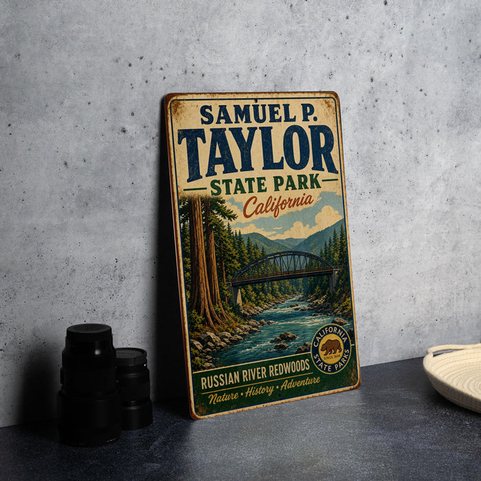A vintage-style metal sign for Samuel P. Taylor State Park in California, featuring a scenic illustration of a river and forest.