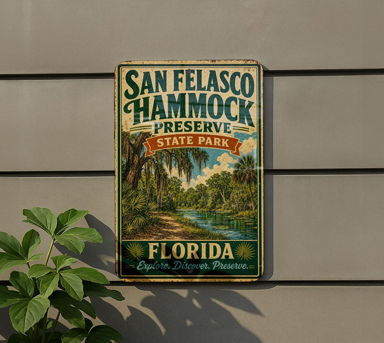 A vintage-style metal sign for San Francisco Hammock Preserve, featuring a tropical landscape with palm trees and a river.