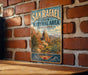 A vintage-style metal sign for San Rafael State Natural Area in Arizona, featuring a scenic illustration of the area's natural landscape.