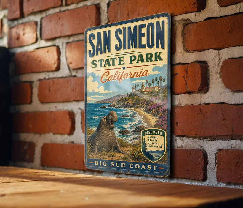 A vintage-style metal sign for San Simeon State Park in California, featuring a scenic illustration of a coastal landscape with a seal.