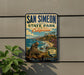 A vintage-style metal sign for San Simeon State Park in California, featuring a scenic image of a coastal landscape with a seal and the text "Discovery of Big Sur Coast".