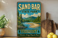 A vintage-style sign for Sand Bar State Park in Vermont, featuring a scenic landscape with a river and mountains.