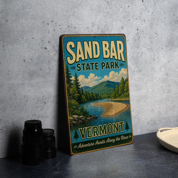 A vintage-style sign for Sand Bar State Park in Vermont, featuring a scenic landscape with a river and mountains.