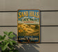 A vintage-style metal sign for Sand Hills State Park in Kansas, featuring a scenic landscape with sunflowers and a message encouraging visitors to explore the Kansas prairie.
