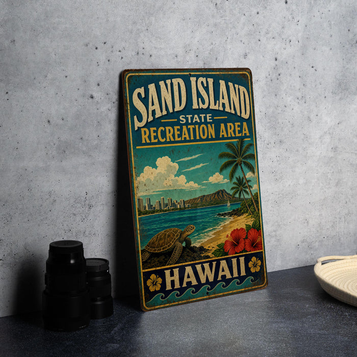 A vintage-style metal sign for the "Sand Island State Recreation Area" in Hawaii, featuring a beach scene with a palm tree, ocean, and hibiscus flowers.