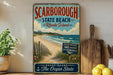 A vintage-style sign for ScARBOROUGH, Rhode Island, featuring a beach scene with a wooden fence and a sign indicating the location.