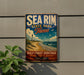 A vintage-style metal sign for Sea Rim State Park in Texas, featuring a lighthouse and beach scene, mounted on a wall.
