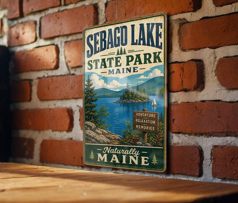 A vintage metal sign for Sebago Lake State Park in Maine, featuring a scenic landscape with a lake, mountains, and pine trees.