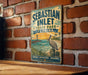 A vintage-style metal sign for Sebastian Inlet State Park in Florida, featuring a pelican and a beach scene.