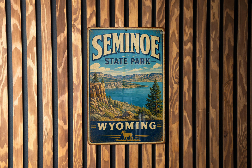 A vintage metal sign for Seminoe State Park in Wyoming, featuring a scenic landscape with mountains, water, and a pine tree.