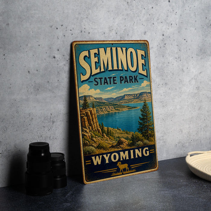 A vintage-style sign for Seminoe State Park in Wyoming, featuring a scenic landscape with mountains, a lake, and a pine tree.