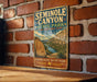 A vintage metal sign for Seminy Canyon, a state park and historic site in Texas, mounted on a brick wall.