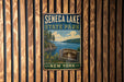 A vintage metal sign for Seneca Lake State Park in New York, featuring a scenic illustration of the lake and surrounding landscape.