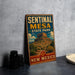 A vintage-style metal sign for sentinel mesa state park in new Mexico, featuring an illustration of the mesa and surrounding landscape.