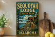 A vintage-style sign for Sequoyah Lodge, a state park in Oklahoma, featuring a scenic illustration of a cabin surrounded by nature.