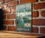 A vintage-style metal sign for Seven Islands State Birding Park in Tennessee, featuring a large blue heron and a scenic landscape.