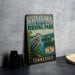 A vintage-style sign for Seven Islands State Birding Park in Tennessee, featuring a large blue heron in a natural setting.