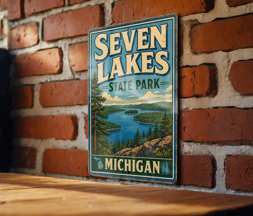 A vintage metal sign for Seven Lakes State Park in Michigan, featuring a scenic landscape with a lake surrounded by mountains and pine trees.
