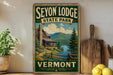 A vintage-style sign for Seyon Lodge State Park in Vermont, featuring a cabin surrounded by a forest and mountains in the background.