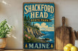 A vintage-style metal sign for Shackford Head State Park in Maine, featuring a scenic coastal landscape with pine trees, cliffs, and a body of water.